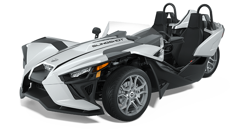 White and black Polaris Slingshot three-wheeled vehicle with roll bars; parked.