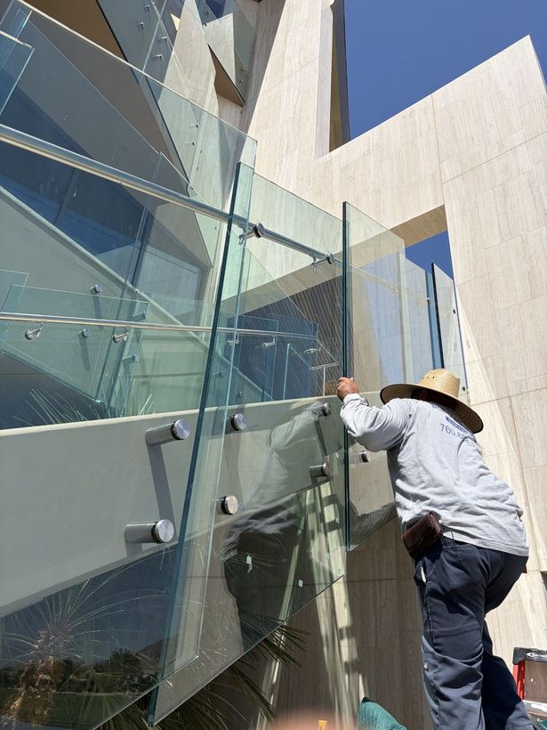 A man is installing a window in a house. A man is installing a window in a house.