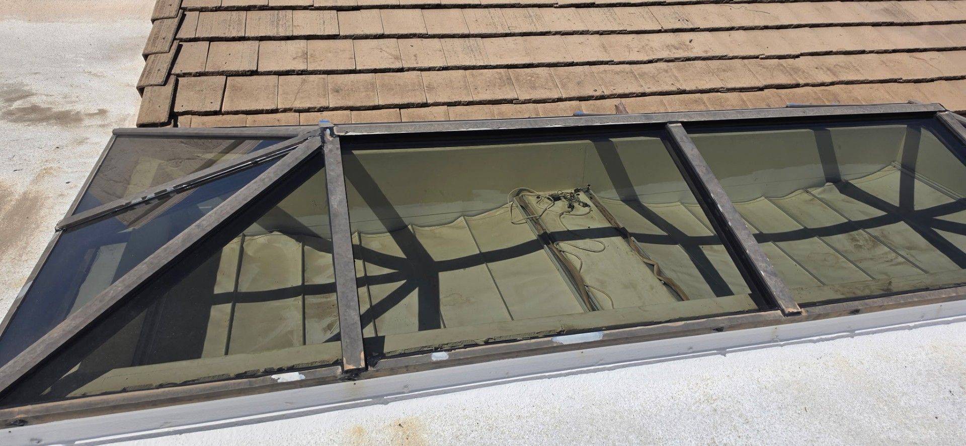 Looking up at a blue sky through a skylight