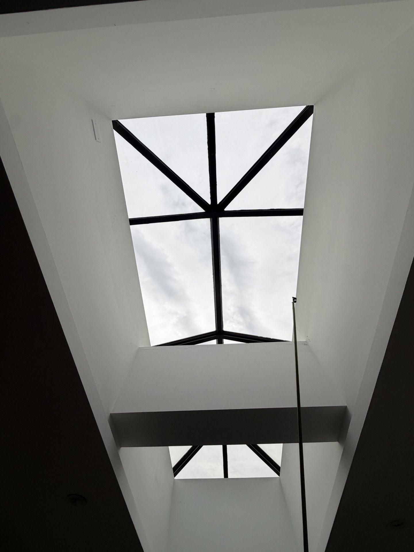 A skylight in the ceiling of a house under construction.
