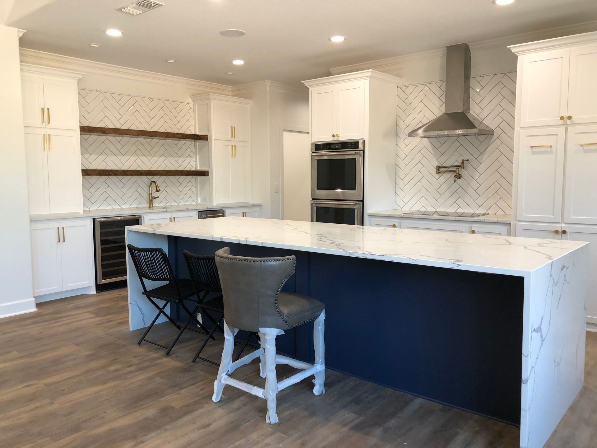 There is a large island in the middle of the kitchen.
