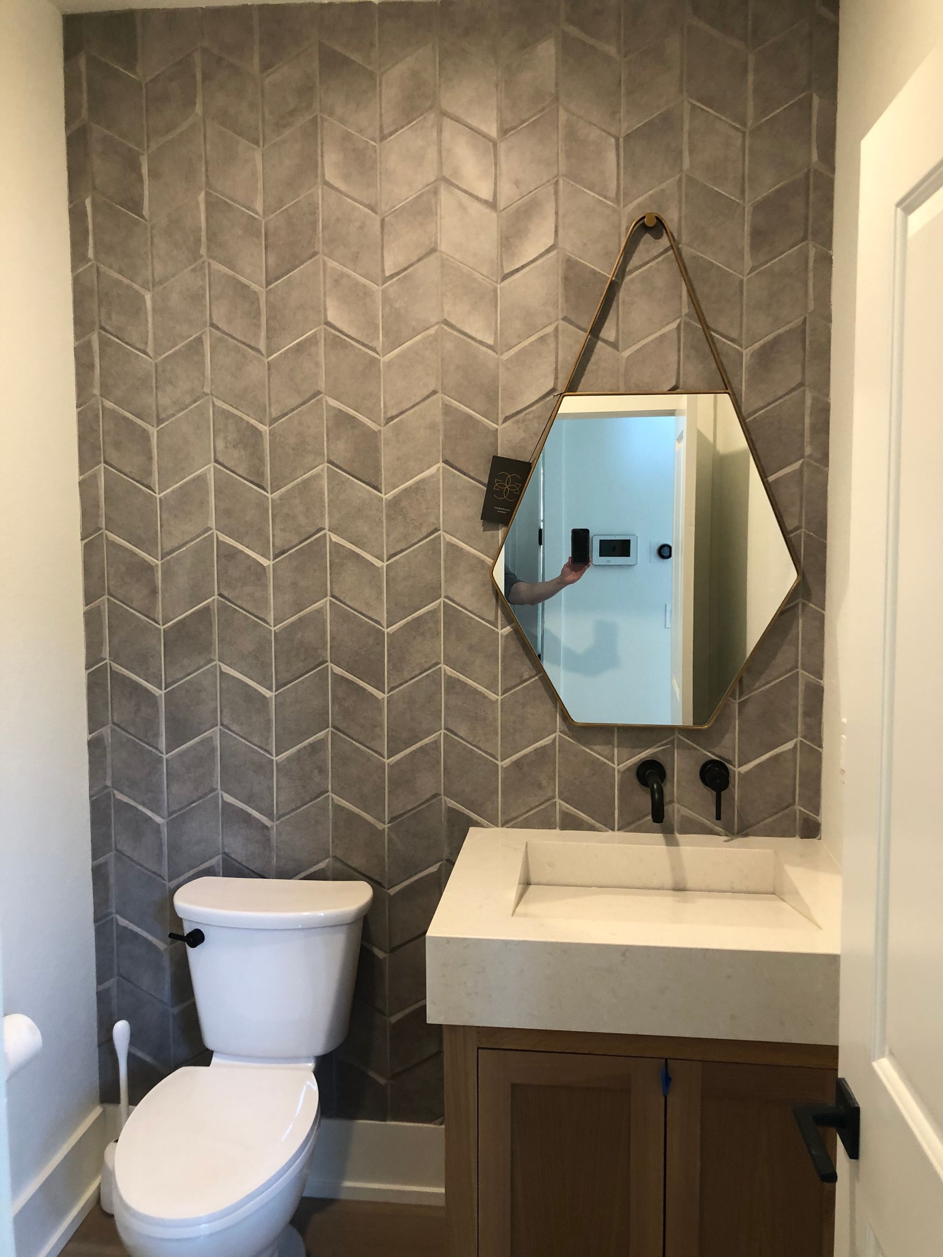 A bathroom with a toilet a sink and a mirror