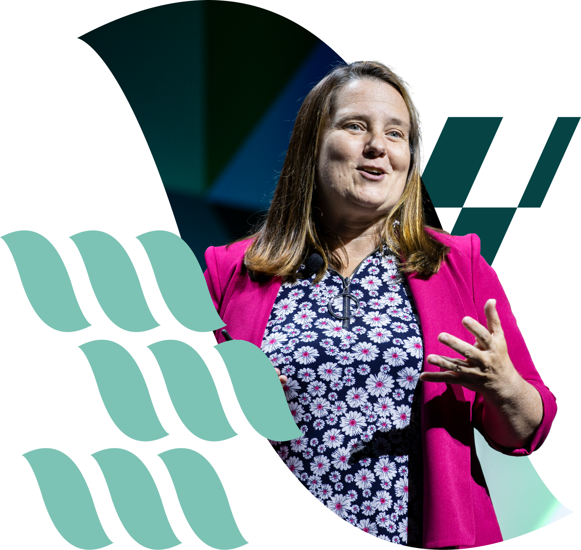 Woman speaking on stage in a bright pink blazer beside abstract teal graphics