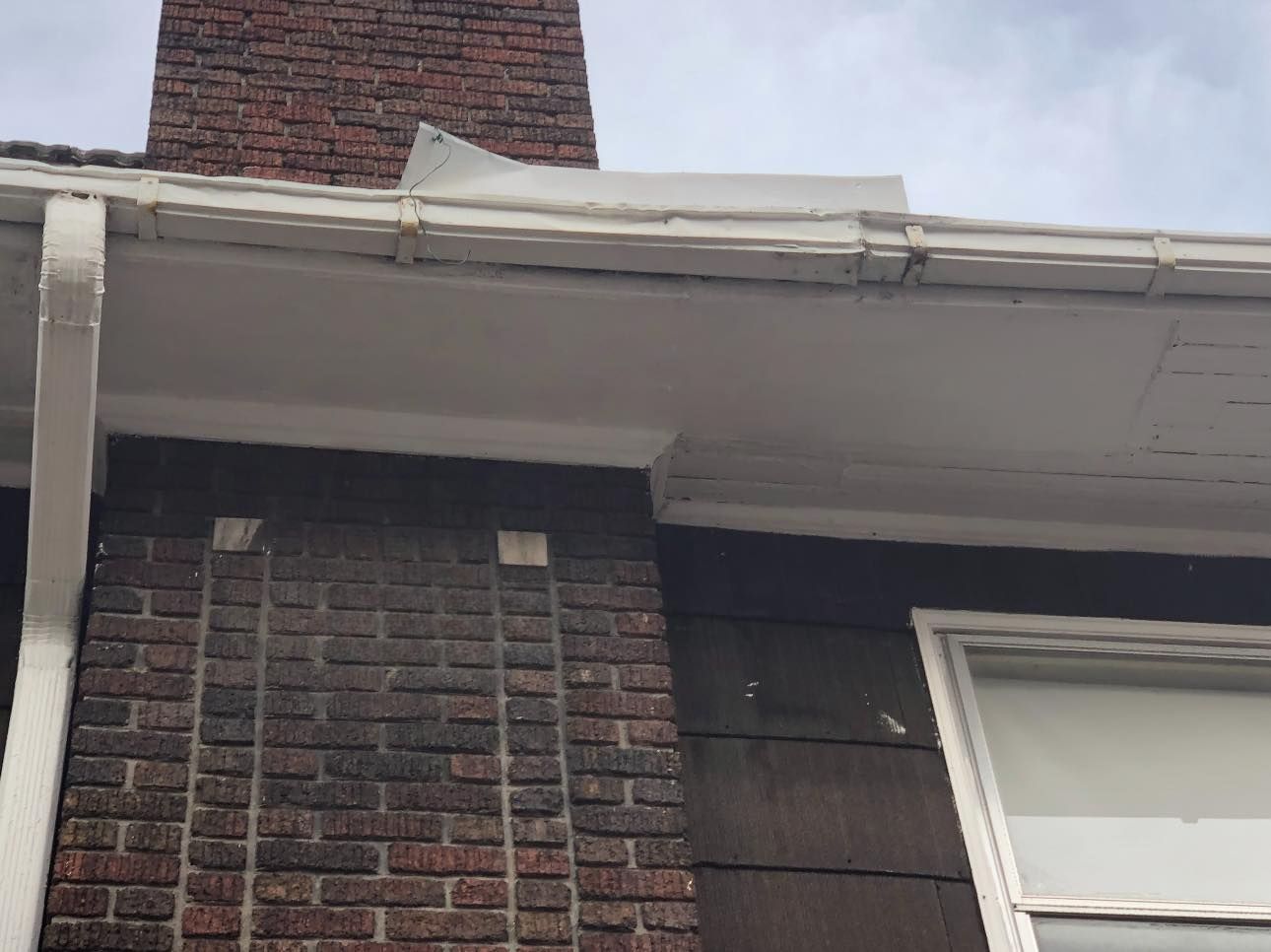 A brick building with a chimney on top of it