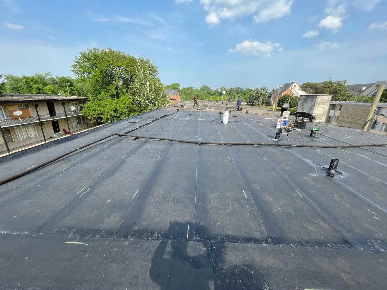 A person is taking a picture of the roof of a building.