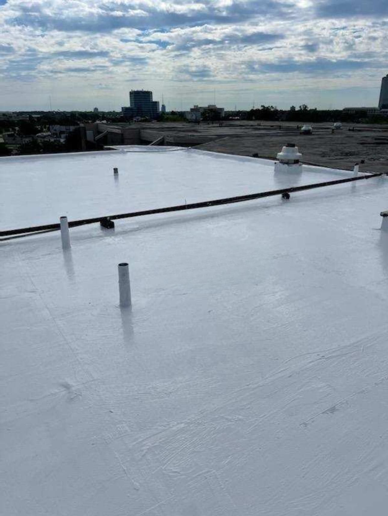 A white roof with a lot of pipes on it.