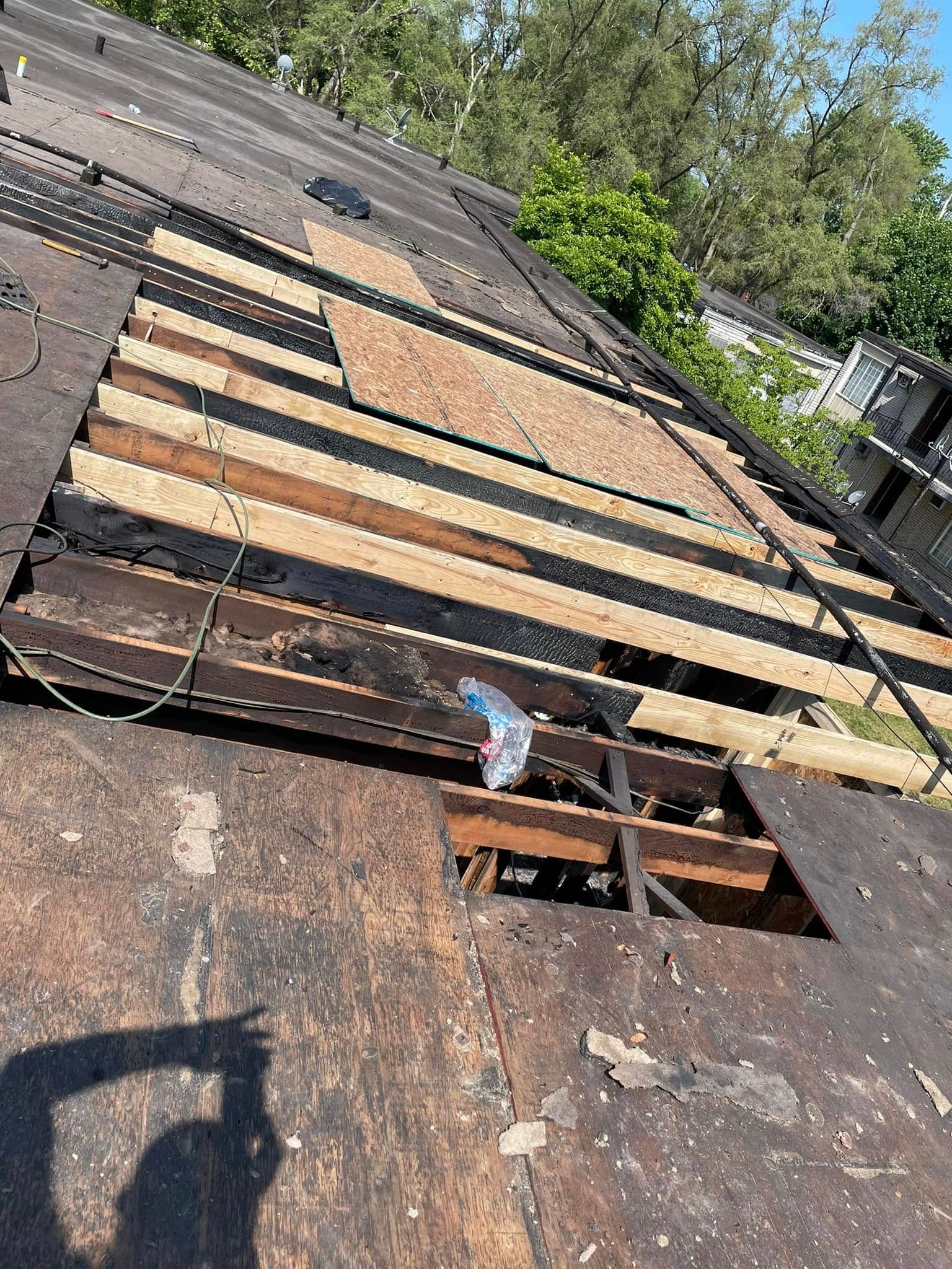 A roof with a hole in it is being repaired.