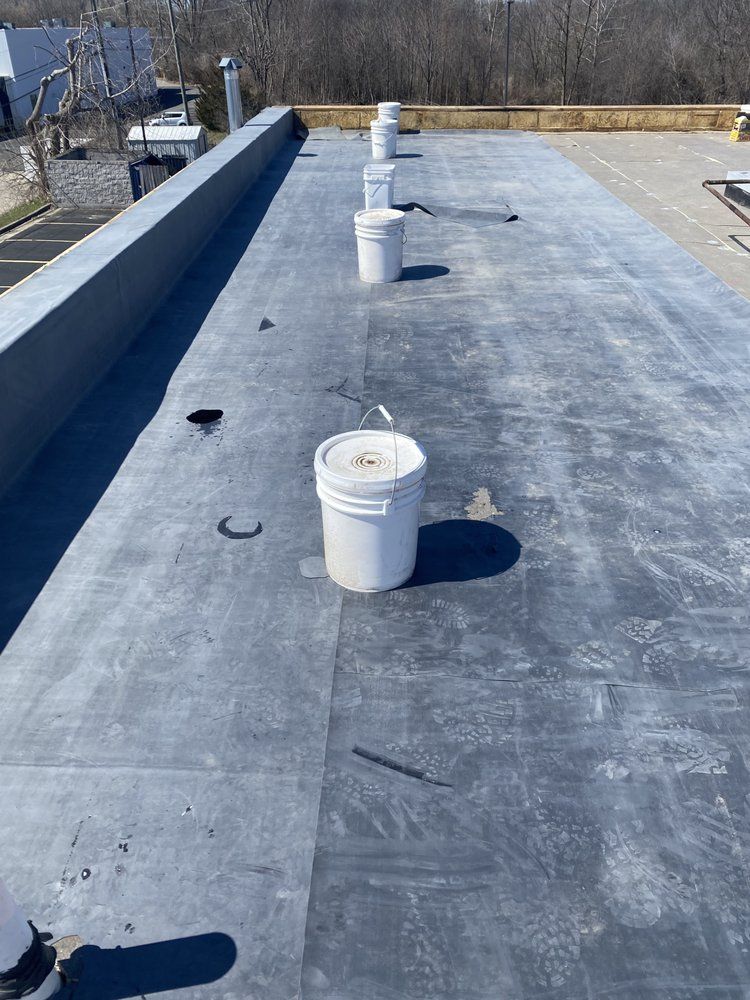 A row of buckets sitting on top of a roof.