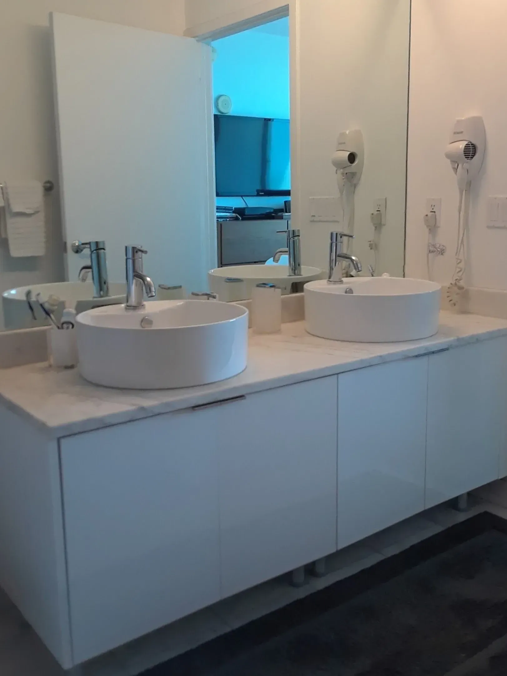 A bathroom with two sinks and a mirror.