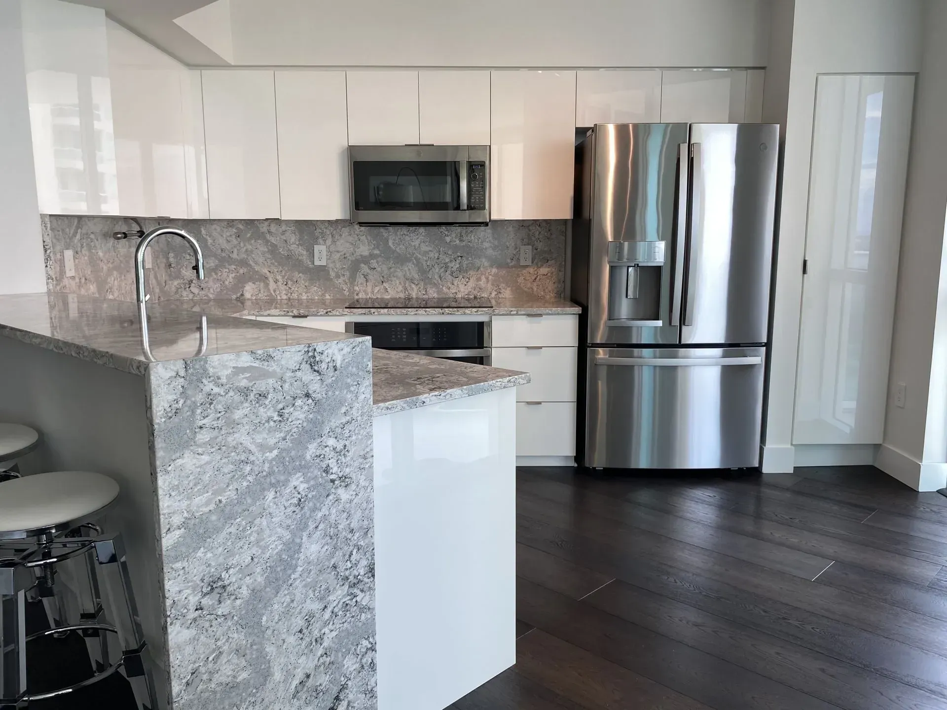 A White kitchen that has gone thru the cabinet refacing transformation project here in Fort Lauderdale.