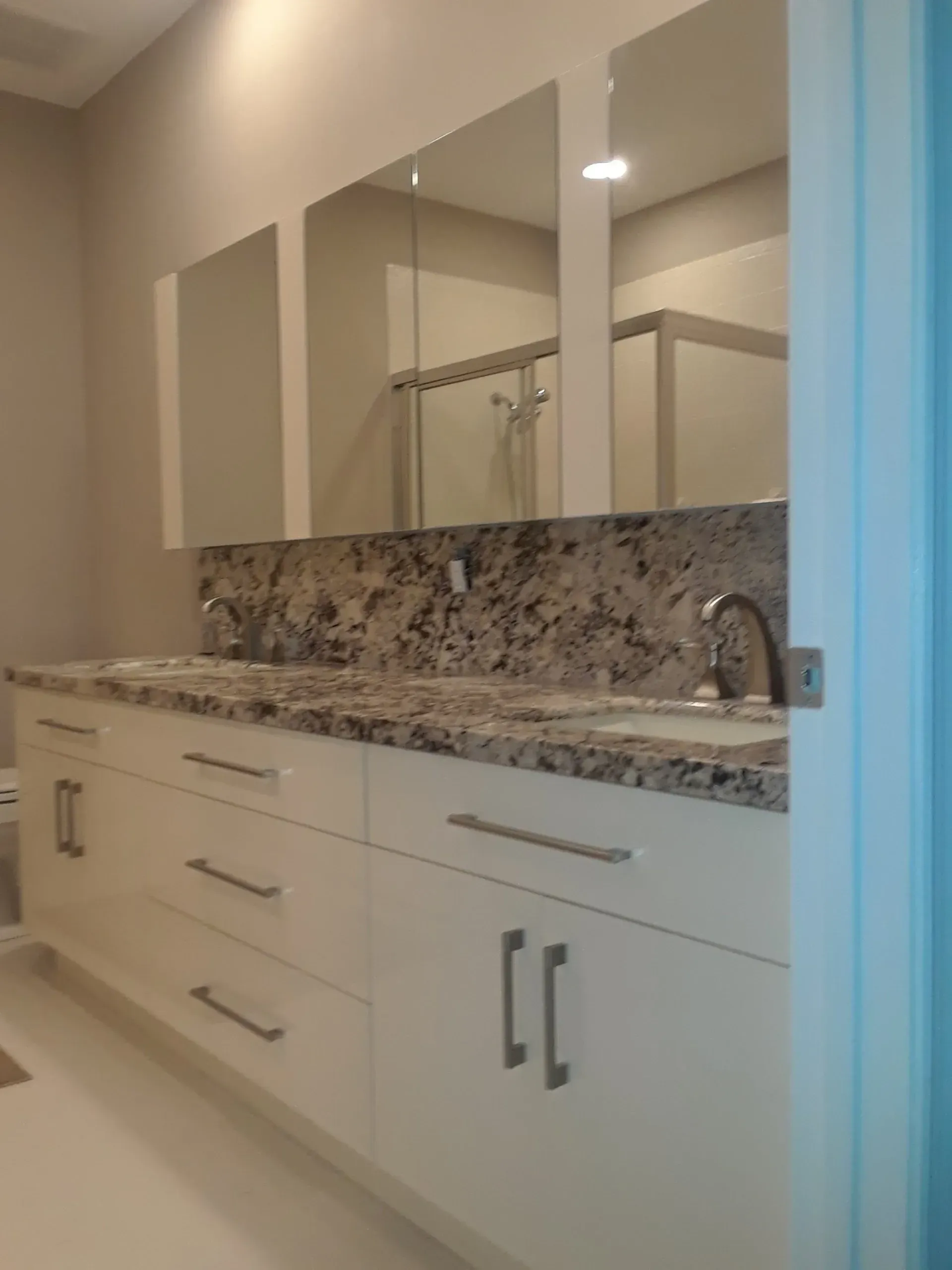 A custom bathroom cabinet with two sinks and a mirror
