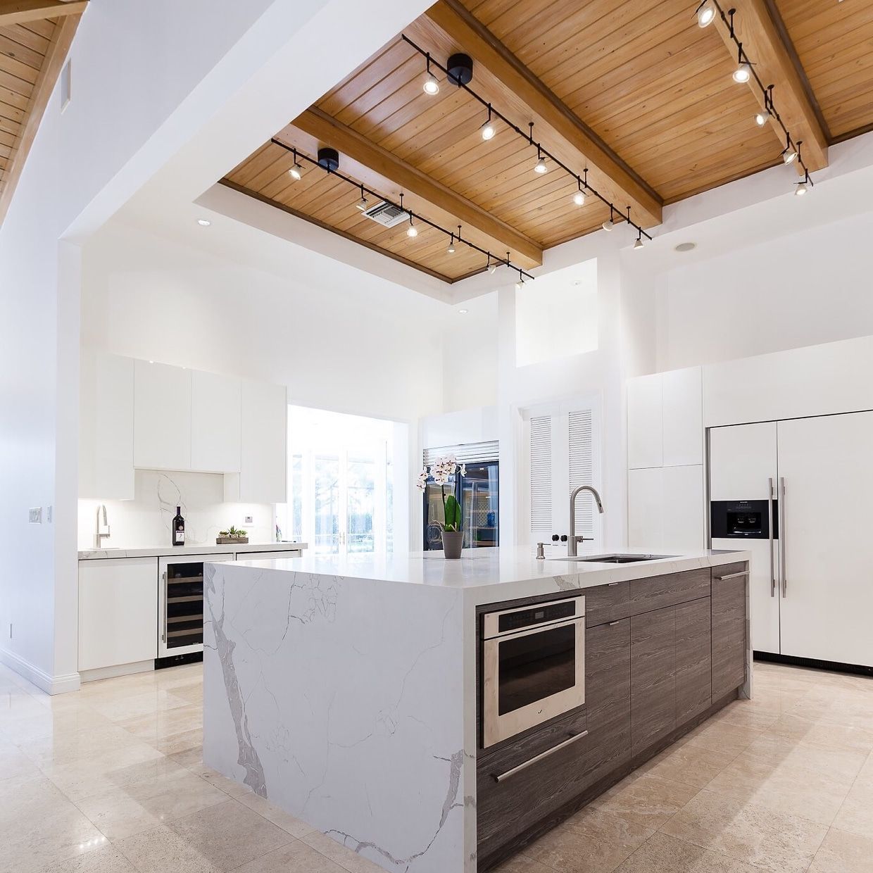 Kitchen cabinets with large island with quartz waterfall | Miami, FL