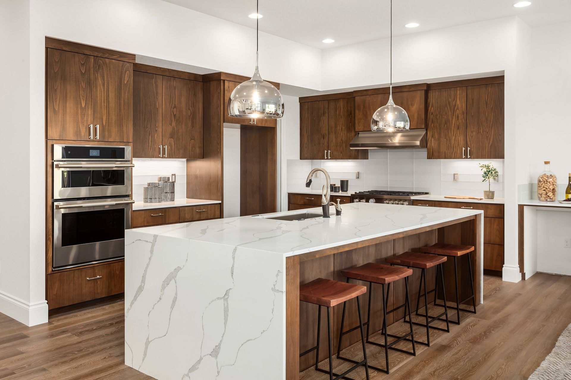 A kitchen Cabinets built to order with large island with quartz waterfall | Weston, FL