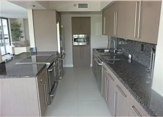 Cabinet refacing for this Taupe colored kitchen with granite countertop in the Miami area.