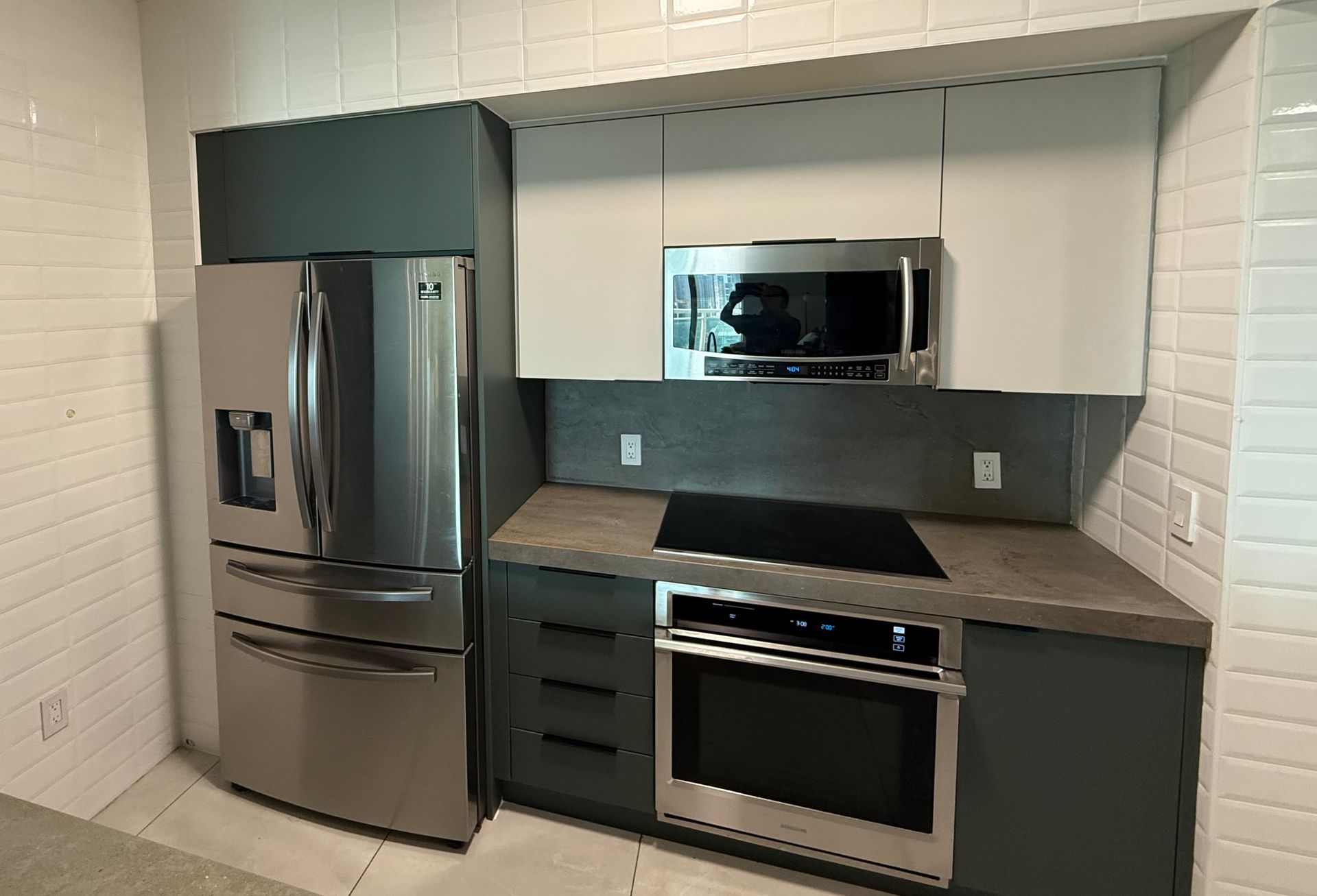 A Refaced kitchen finished in Matte Cashmere and Hunter Green with a slate countertop in Brickell, FL