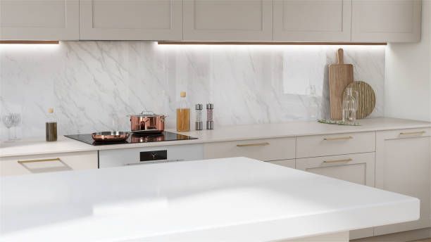 A kitchen with white cabinets , stainless steel appliances and granite counter tops.