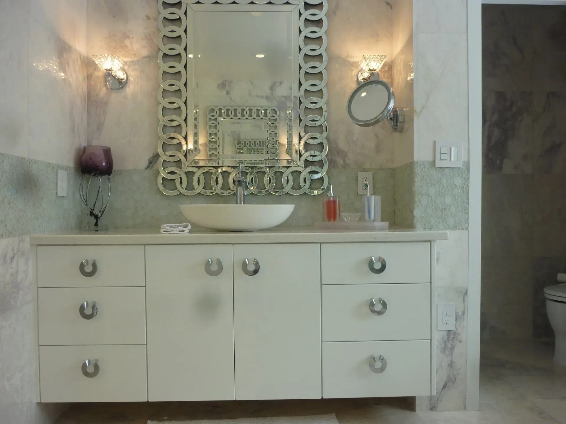 A bathroom with a sink and a large mirror