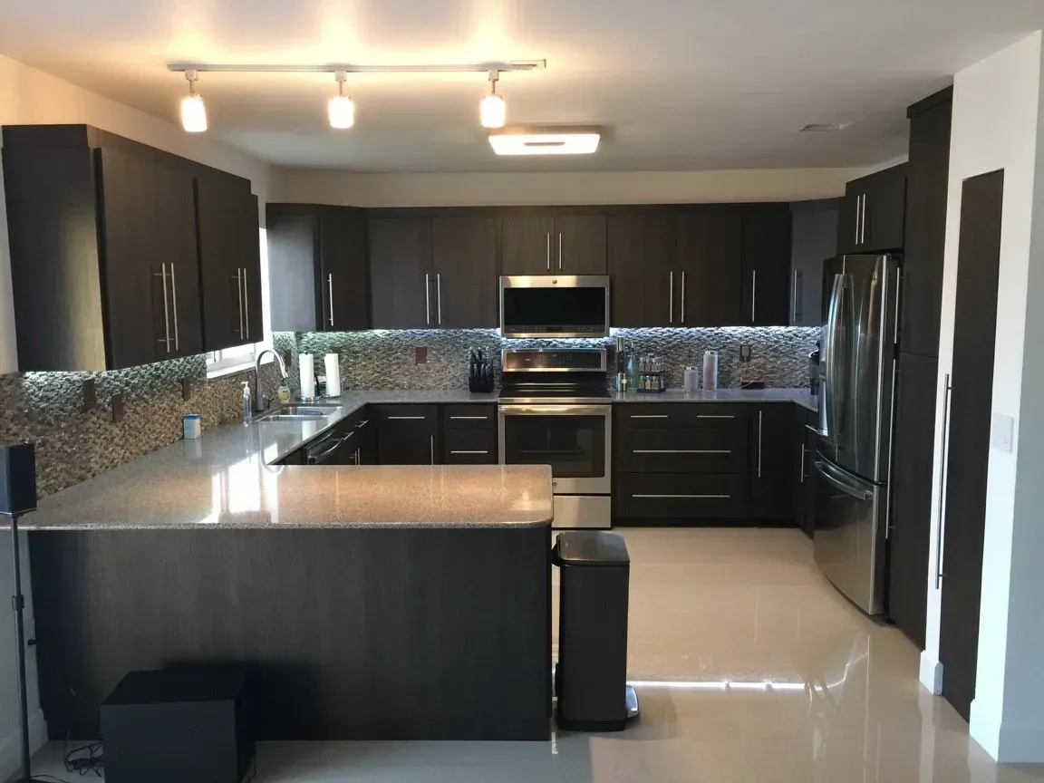 Refacing kitchen cabinets in dark expresso color with granite countertop
