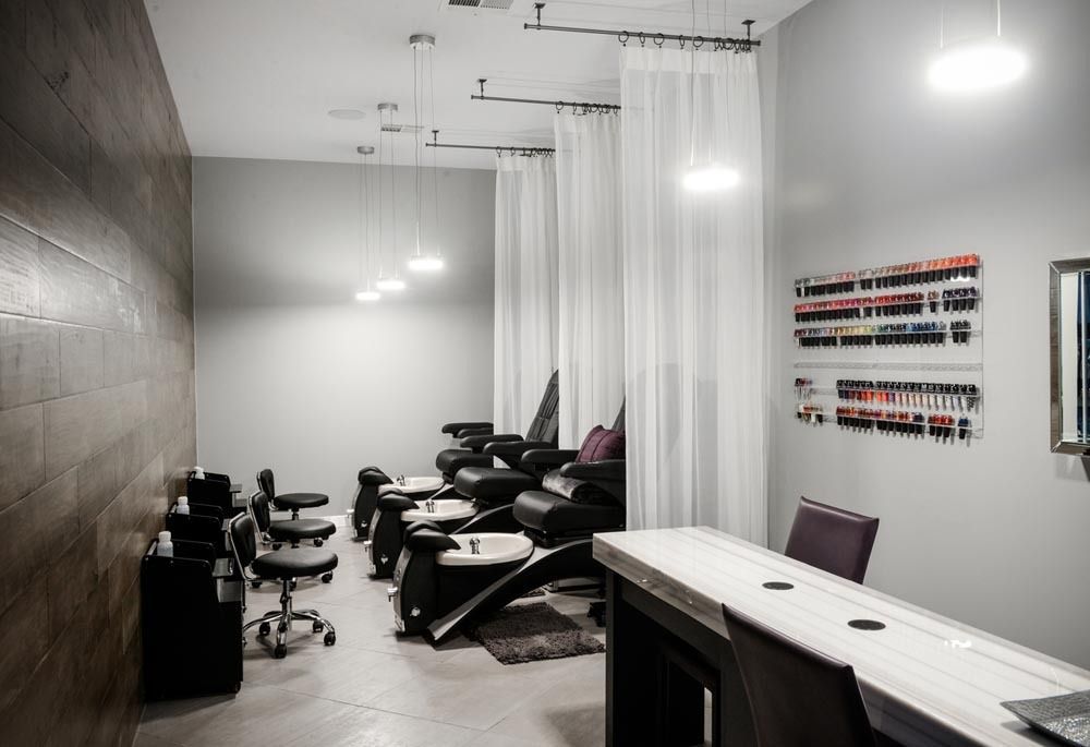 Modern tattoo studio with chairs, workstations, and hanging white curtains