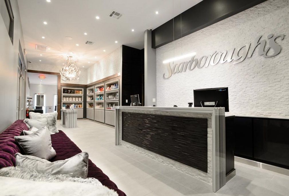 Modern eyewear store interior with white walls, display shelves, and a reception counter