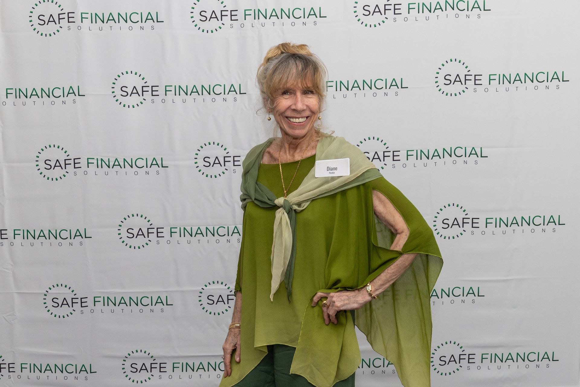 Woman in green outfit at an event with a 