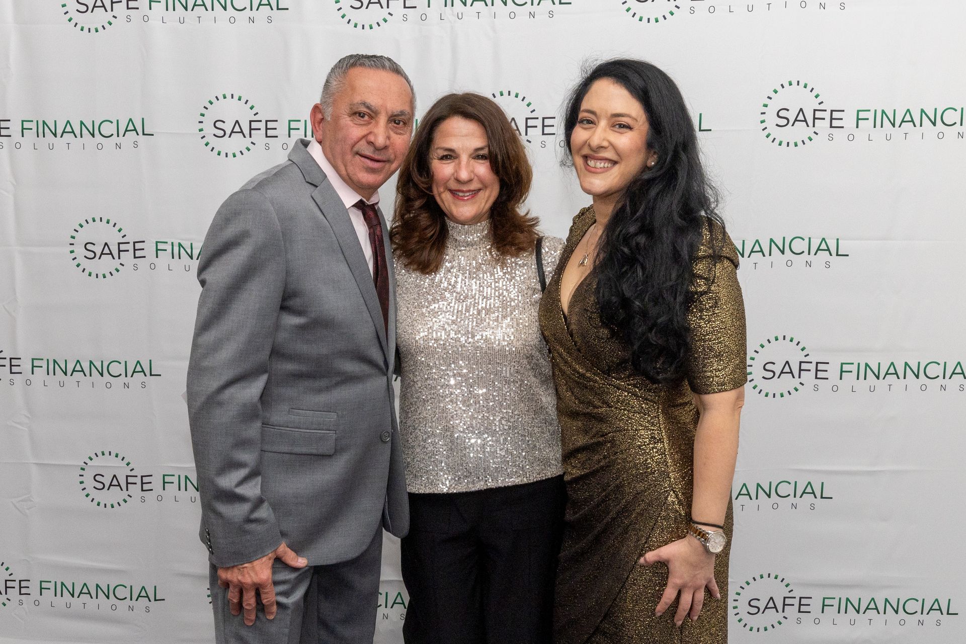 Three people smiling at a 