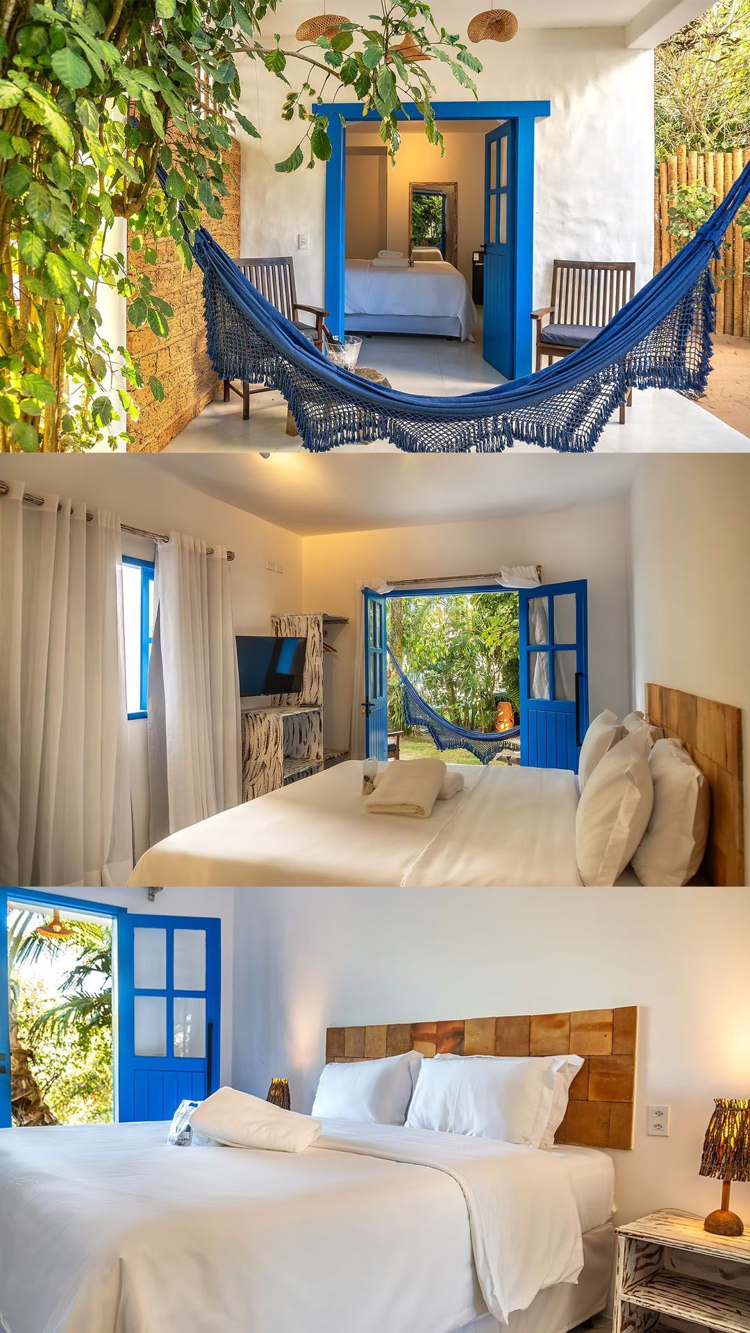 Quarto luminoso com roupa de cama branca, portas azuis e rede, com acesso a uma varanda com vista para uma paisagem tropical.