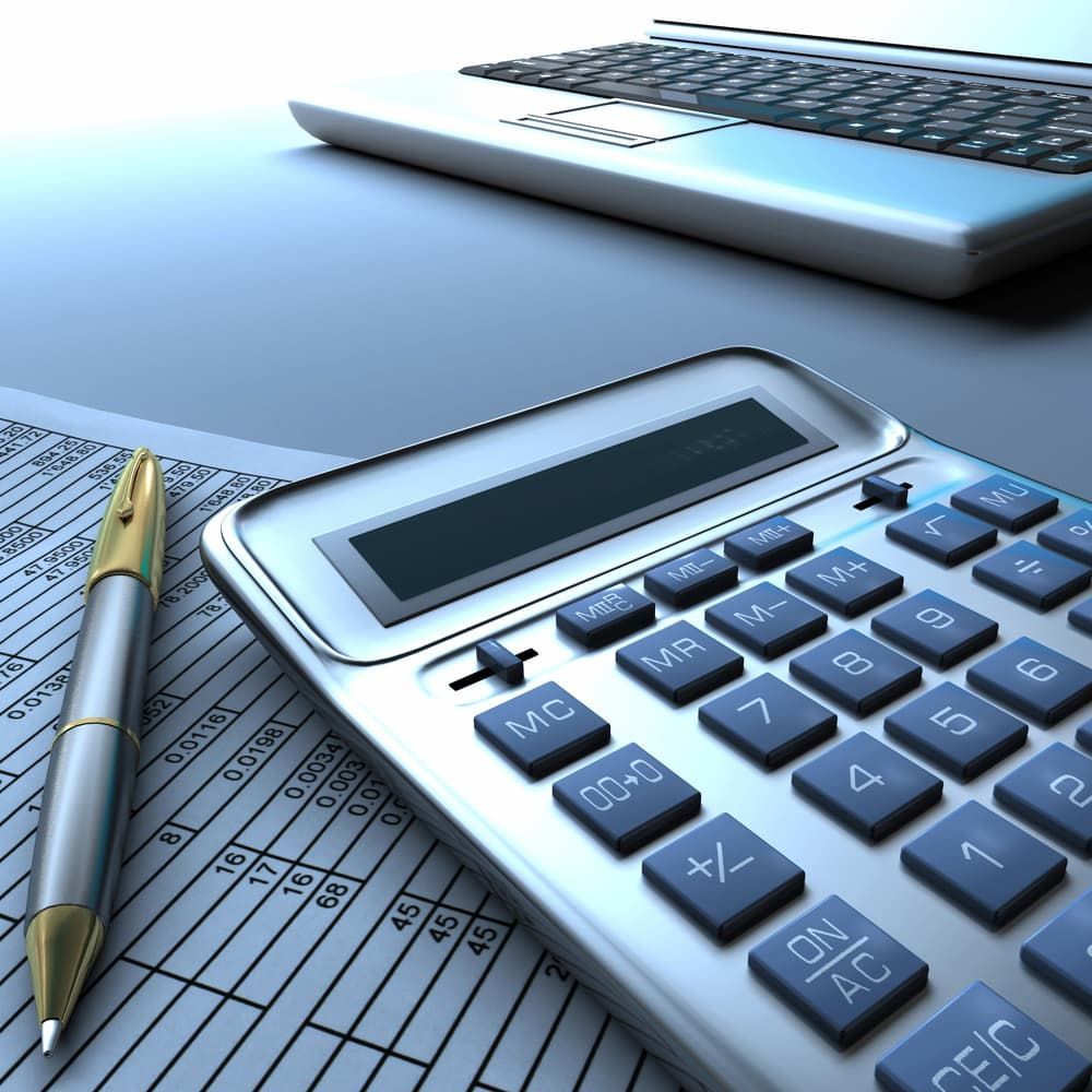 Calculator and Pen on a Document, With a Laptop — NR Bookkeeping in Bangalow, NSW
