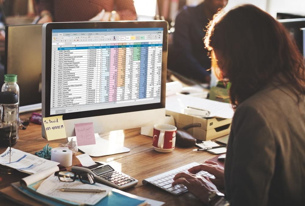 A Woman Is Sitting at A Desk Working on A Computer — NR Bookkeeping In Alstonville, NSW