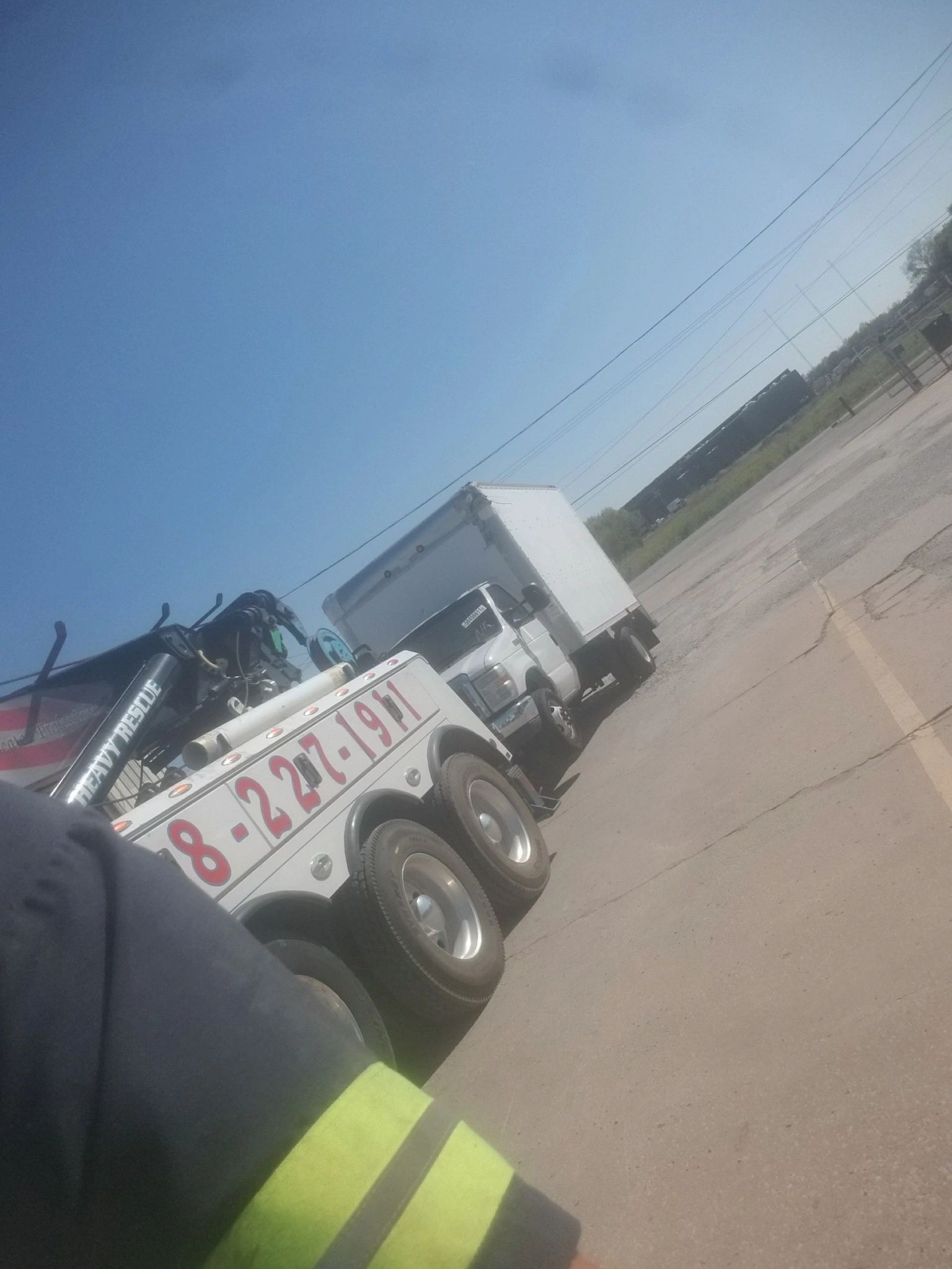 A tow truck with the number 8-22 on the side of it is parked in a parking lot.