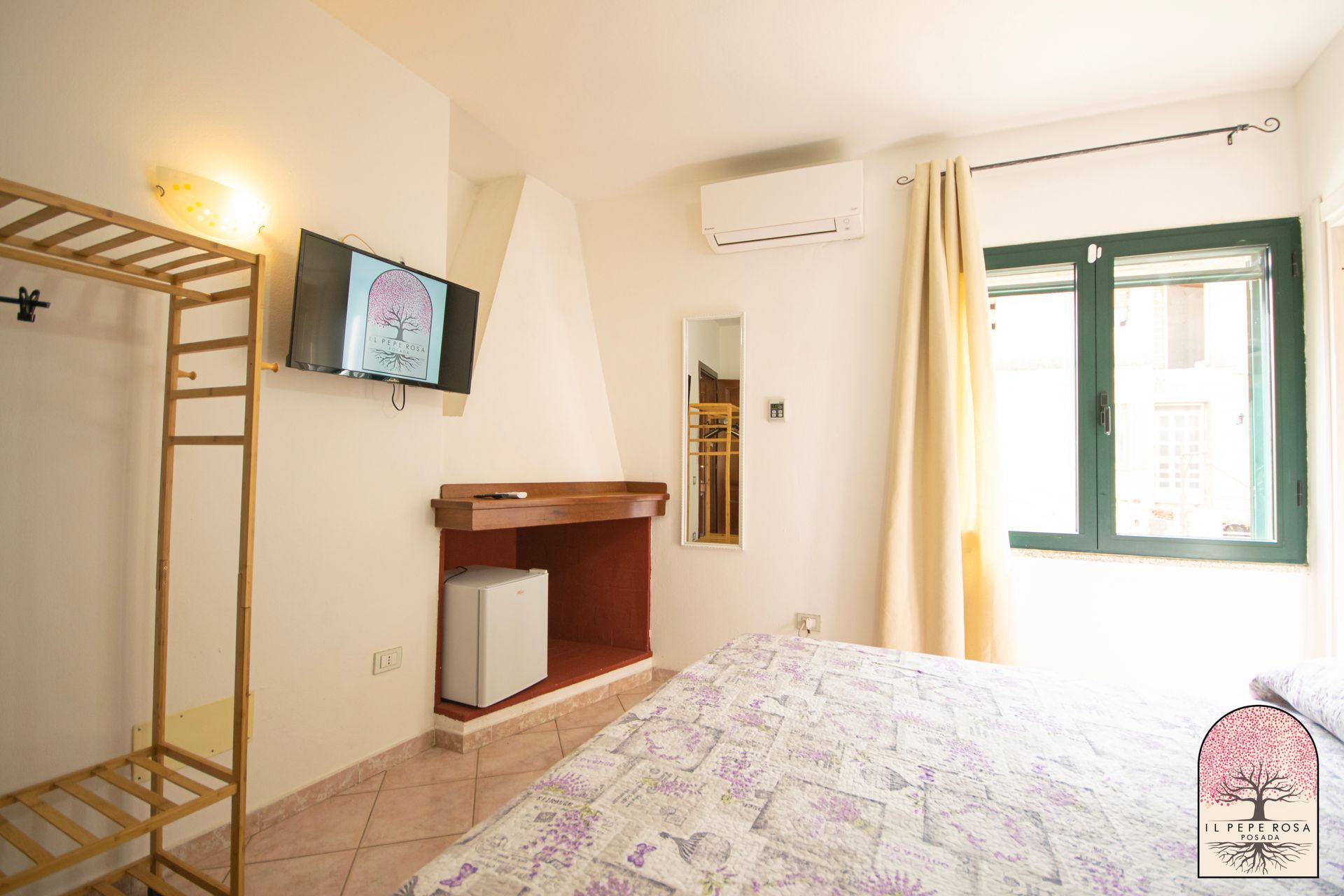 Una camera da letto con un letto, una televisione e una finestra