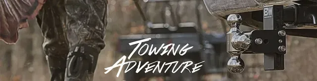 Person's legs next to a tow hitch with the words