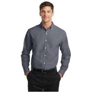 A man is wearing a gray shirt and black pants.