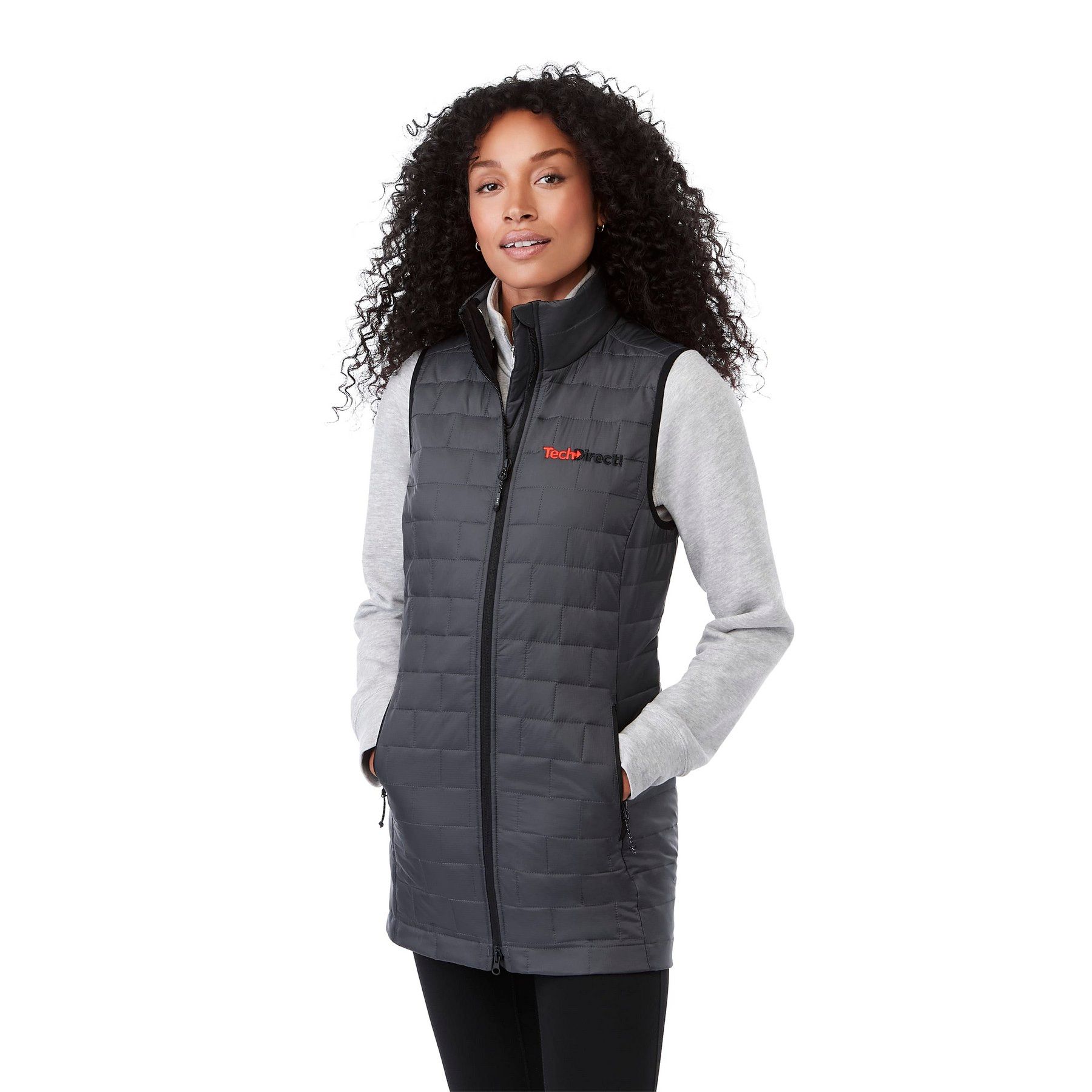 A woman is wearing a gray vest and a gray sweater.