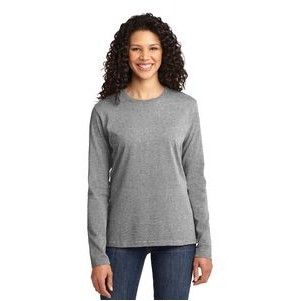 A woman is wearing a grey long sleeve t-shirt and jeans.
