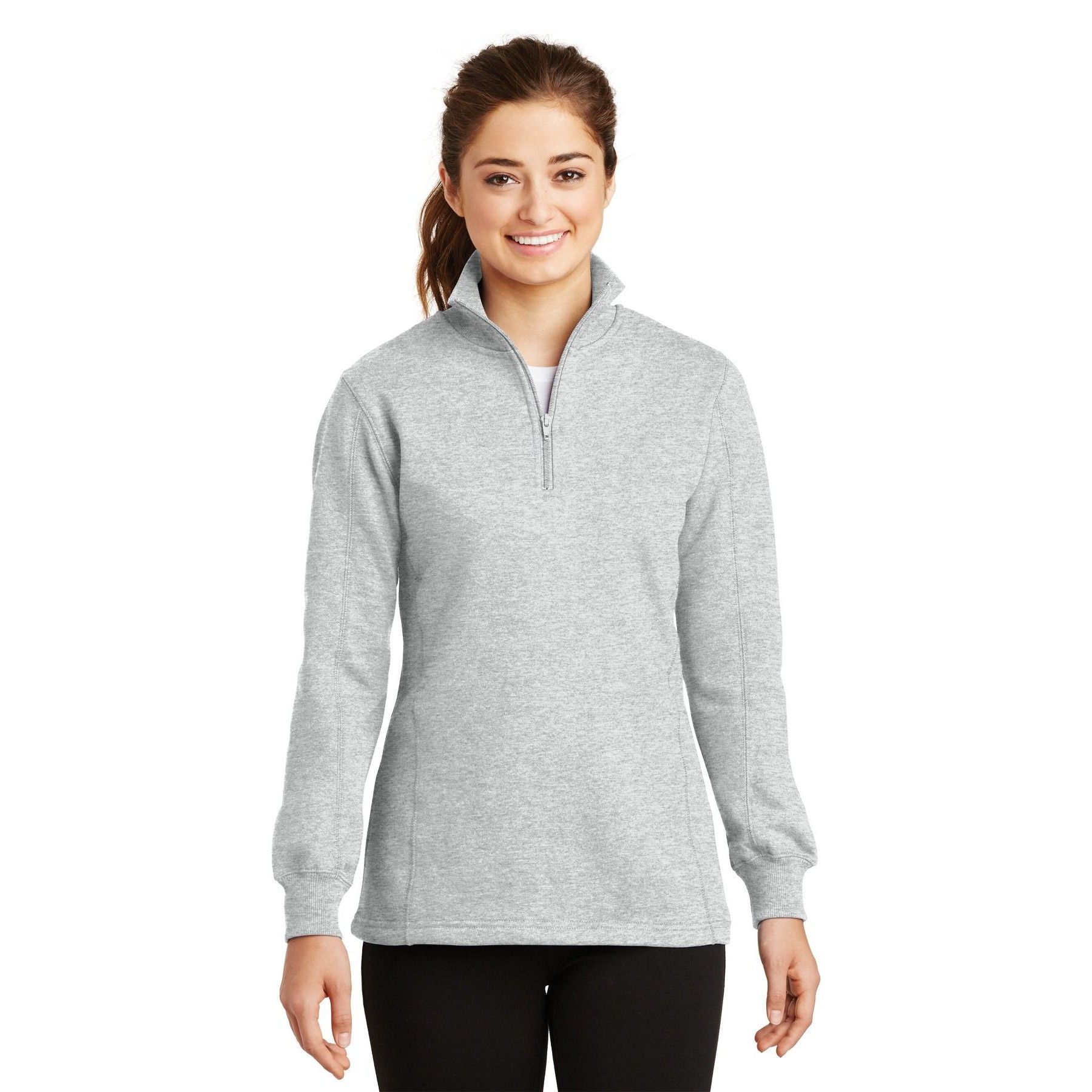 A woman is wearing a grey sweatshirt and black pants