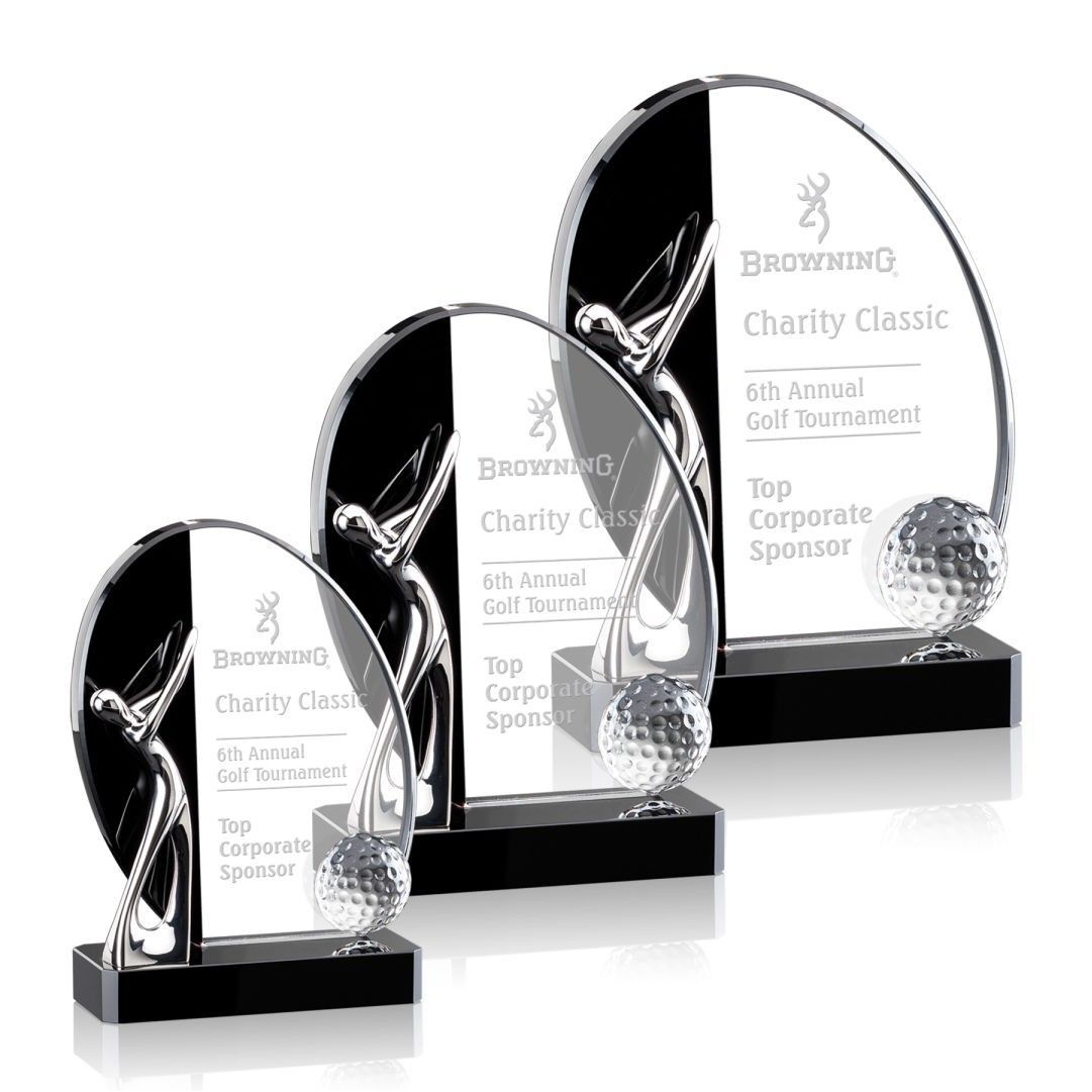 Three trophies are sitting next to each other on a white background.