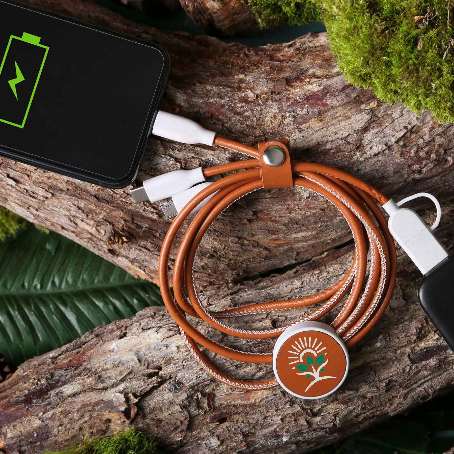 A cell phone is being charged by a brown cable