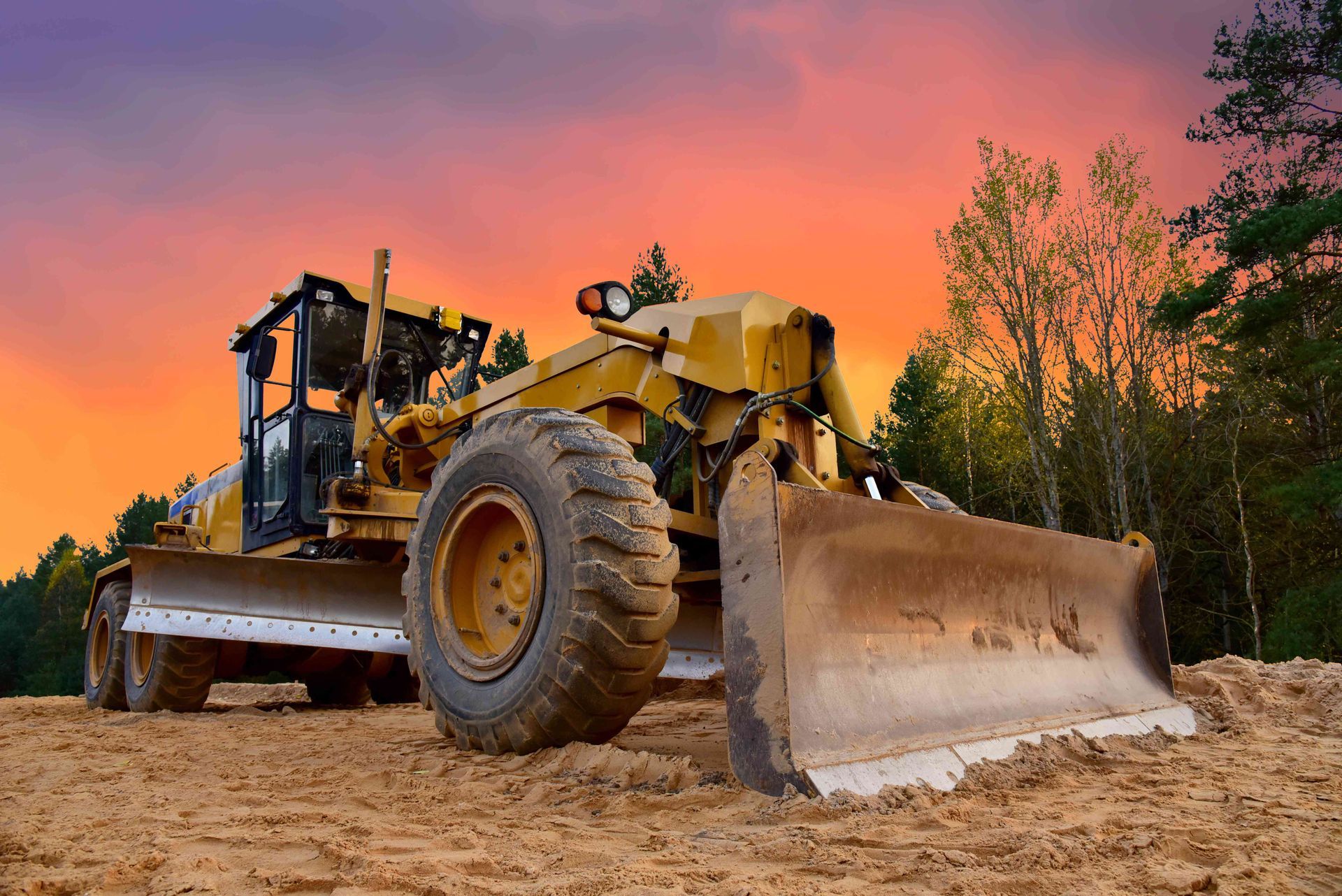 a bulldozer is sitting on top of a dirt field