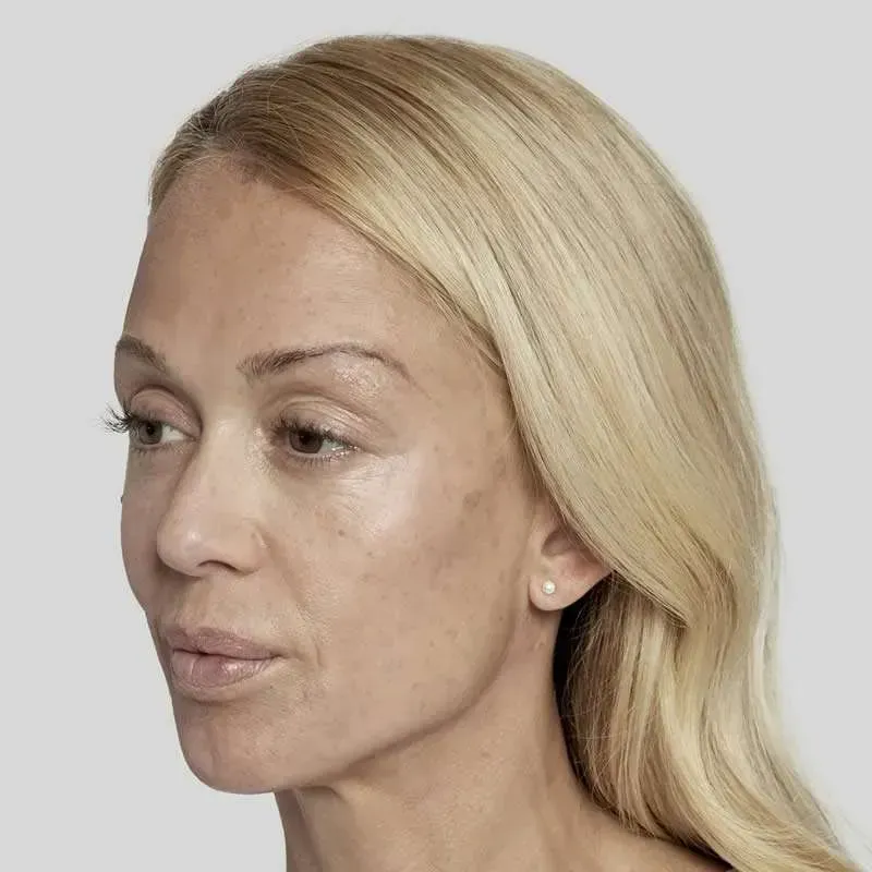 A close up of a woman 's face with blonde hair and earrings.