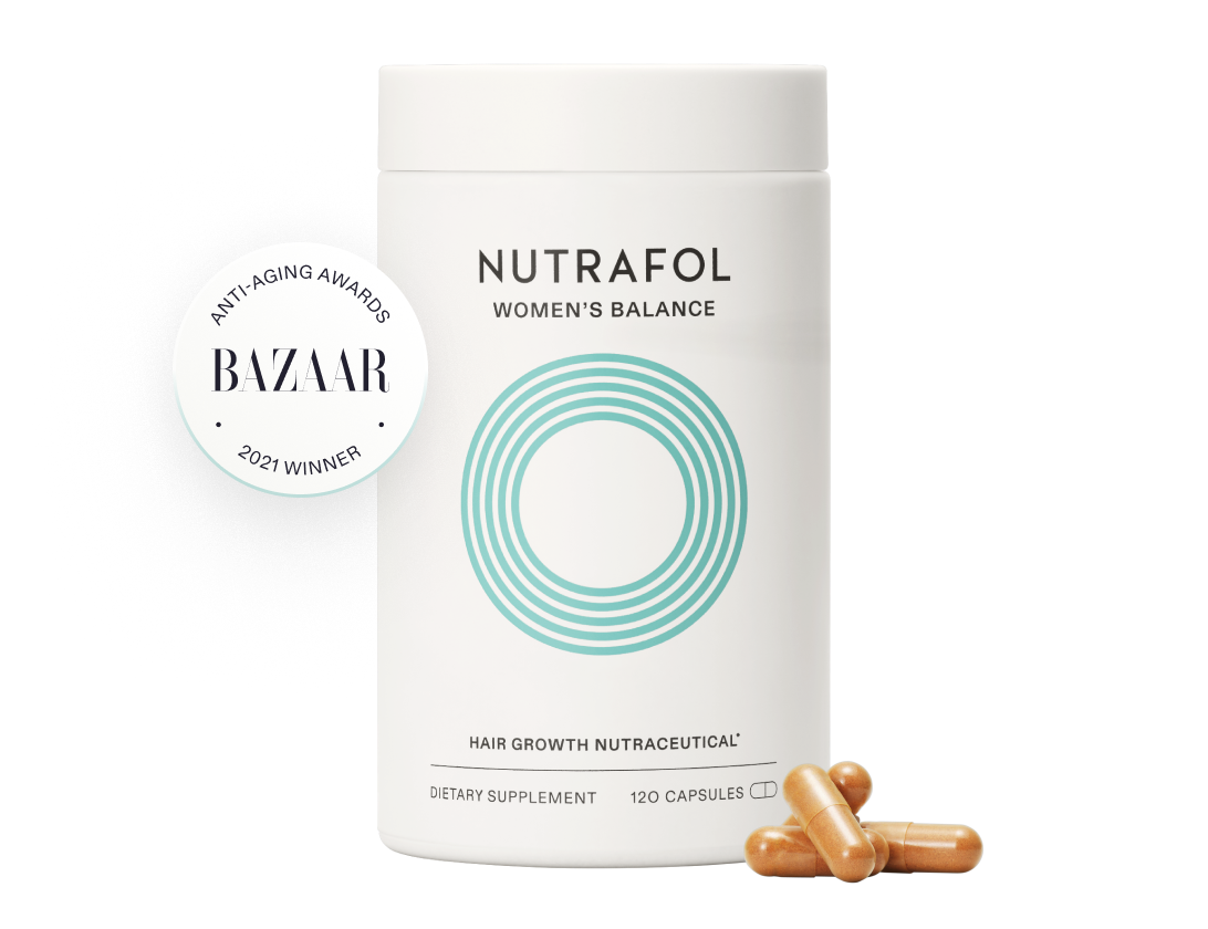 A bottle of nutrafol women 's balance is sitting on a table.