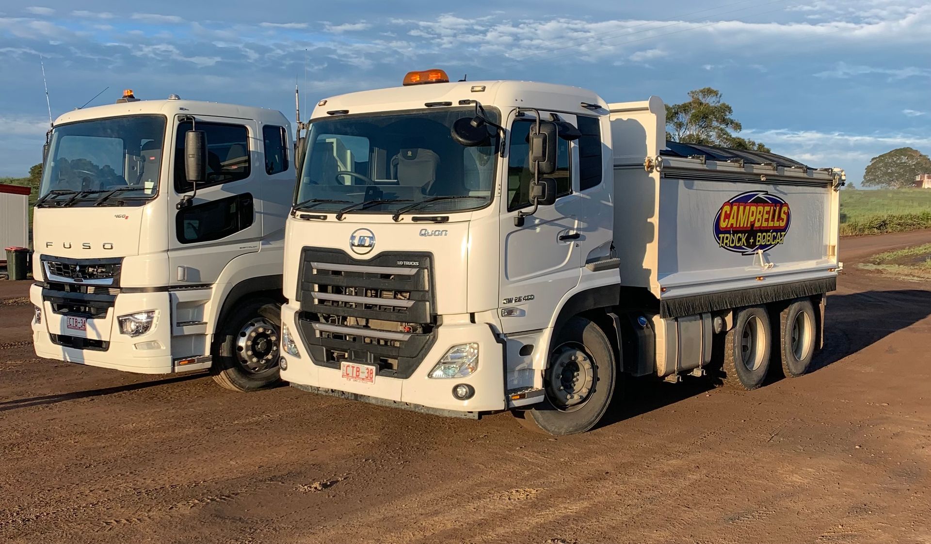Two White Trucks Are Parked Next to Each Other — Campbell's Truck and Bobcat and Landscape Supplies In Gympie, QLD