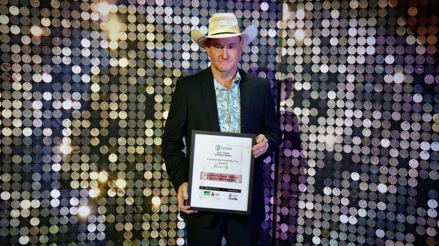 Man in Cowboy Hat Holds Award — Campbell's Truck and Bobcat and Landscape Supplies In Gympie, QLD