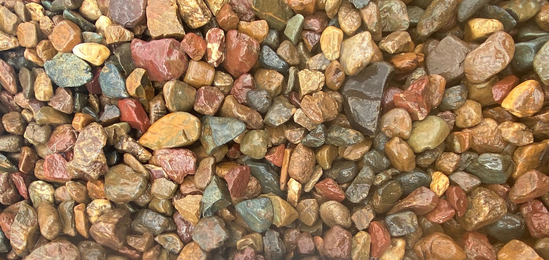 A large rock is sitting on top of a pile of gravel — Campbell's Truck and Bobcat and Landscape Supplies In Gympie, QLD