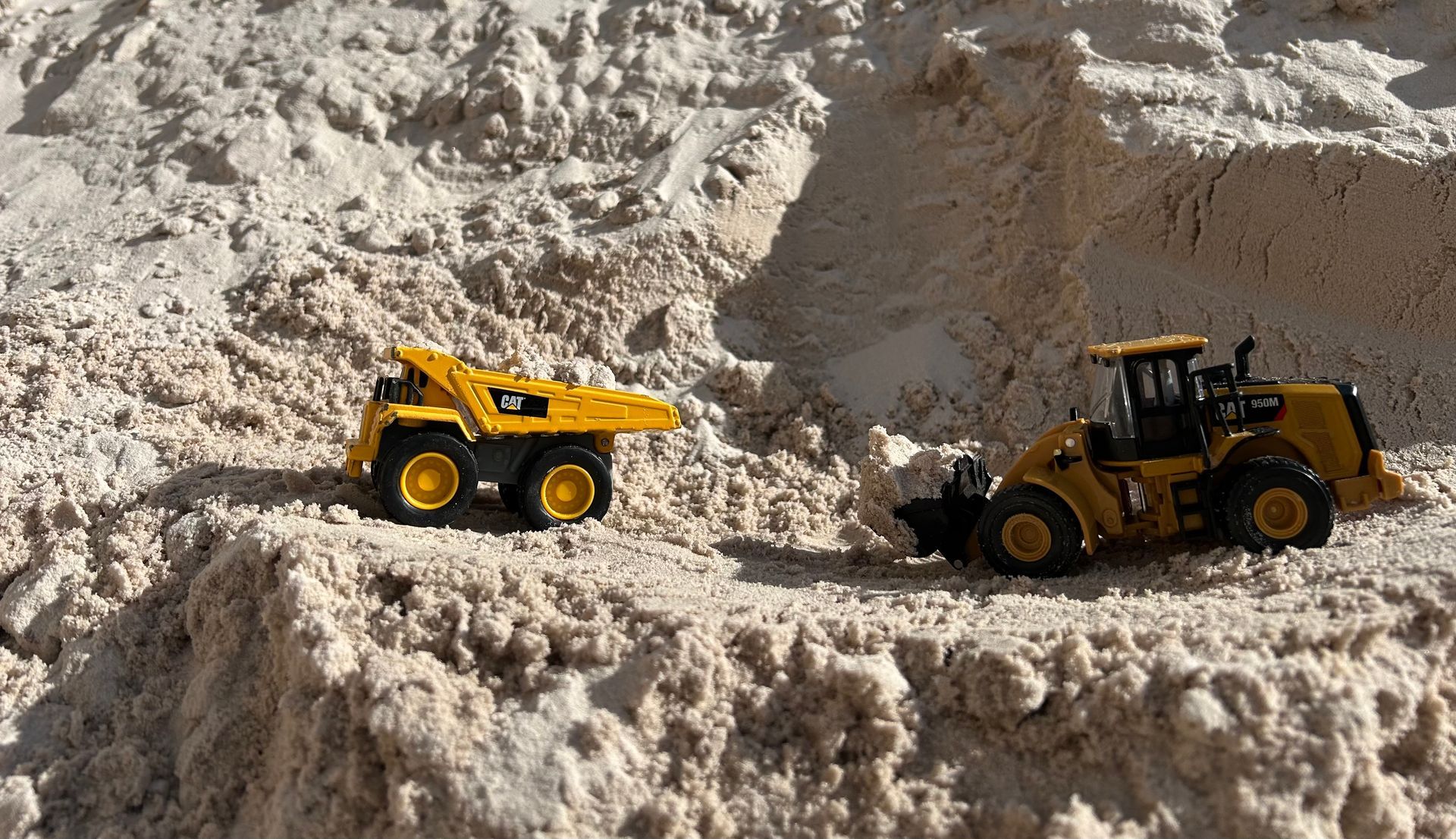 A Person is Spreading Sand on the Ground With a Trowel — Campbell's Truck and Bobcat and Landscape Supplies In Gympie, QLD