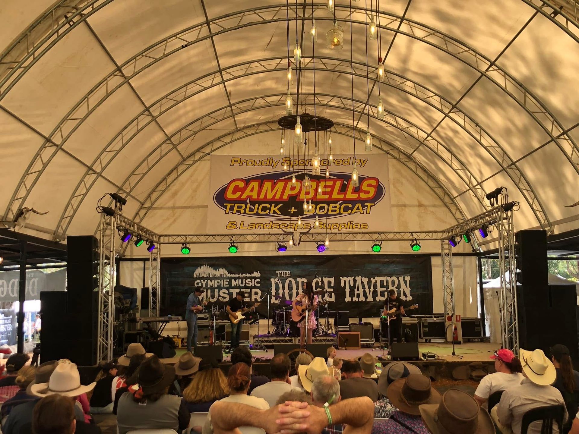 Live Music Stage Under a Tent With a Campbell’s Banner — Campbell's Truck and Bobcat and Landscape Supplies In Gympie, WLD