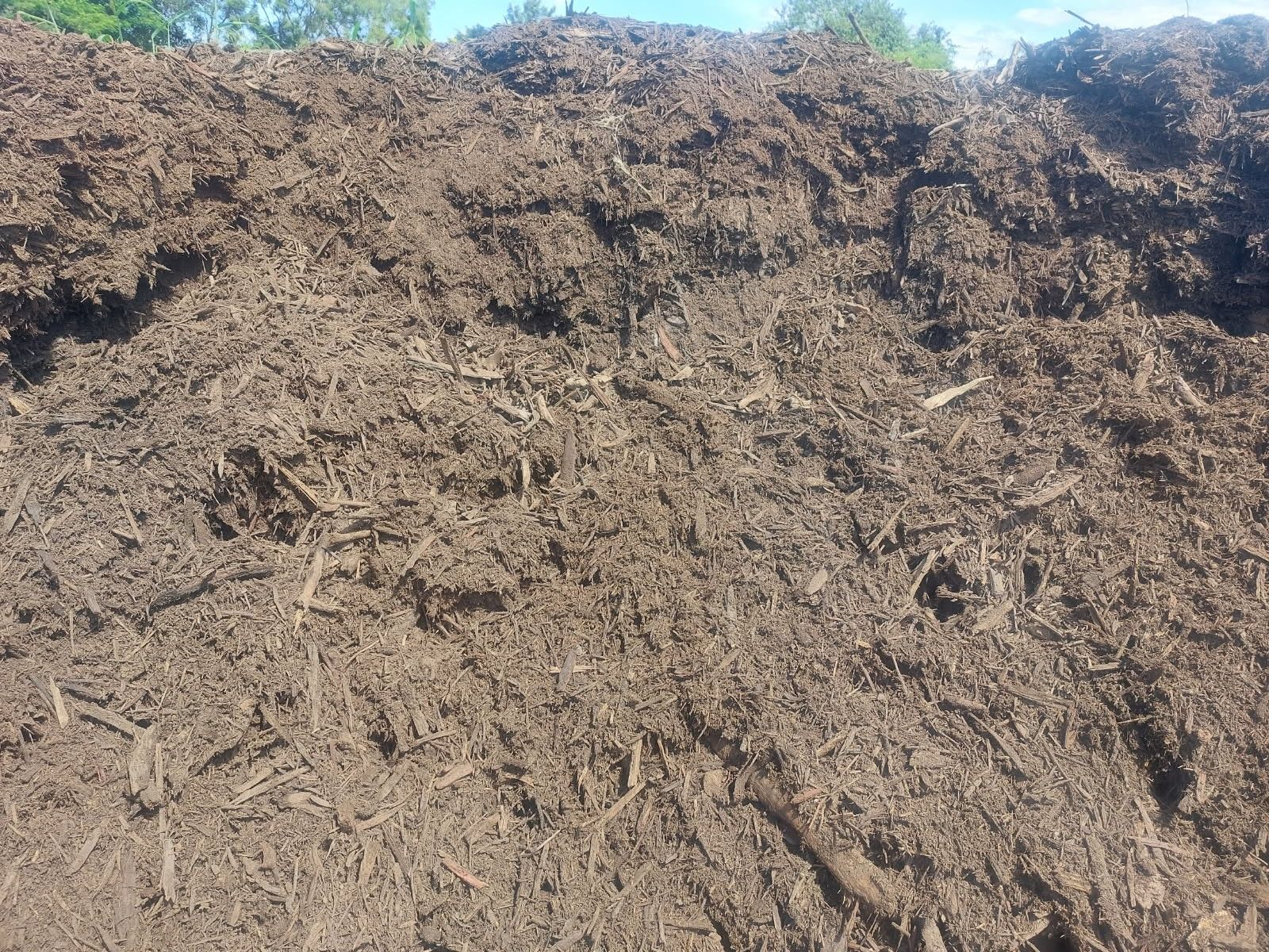 A Large Mound of Brown Mulch — Campbell's Truck and Bobcat and Landscape Supplies In Gympie, QLD
