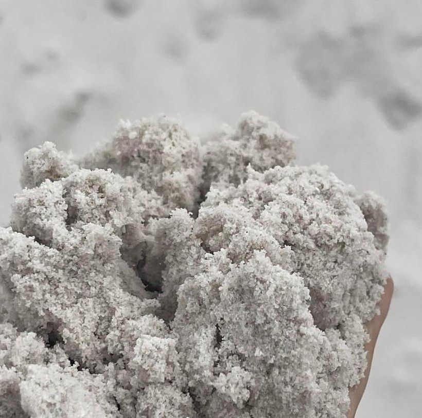 Hand Holding a Clump of White Sand — Campbell's Truck and Bobcat and Landscape Supplies In Gympie, QLD