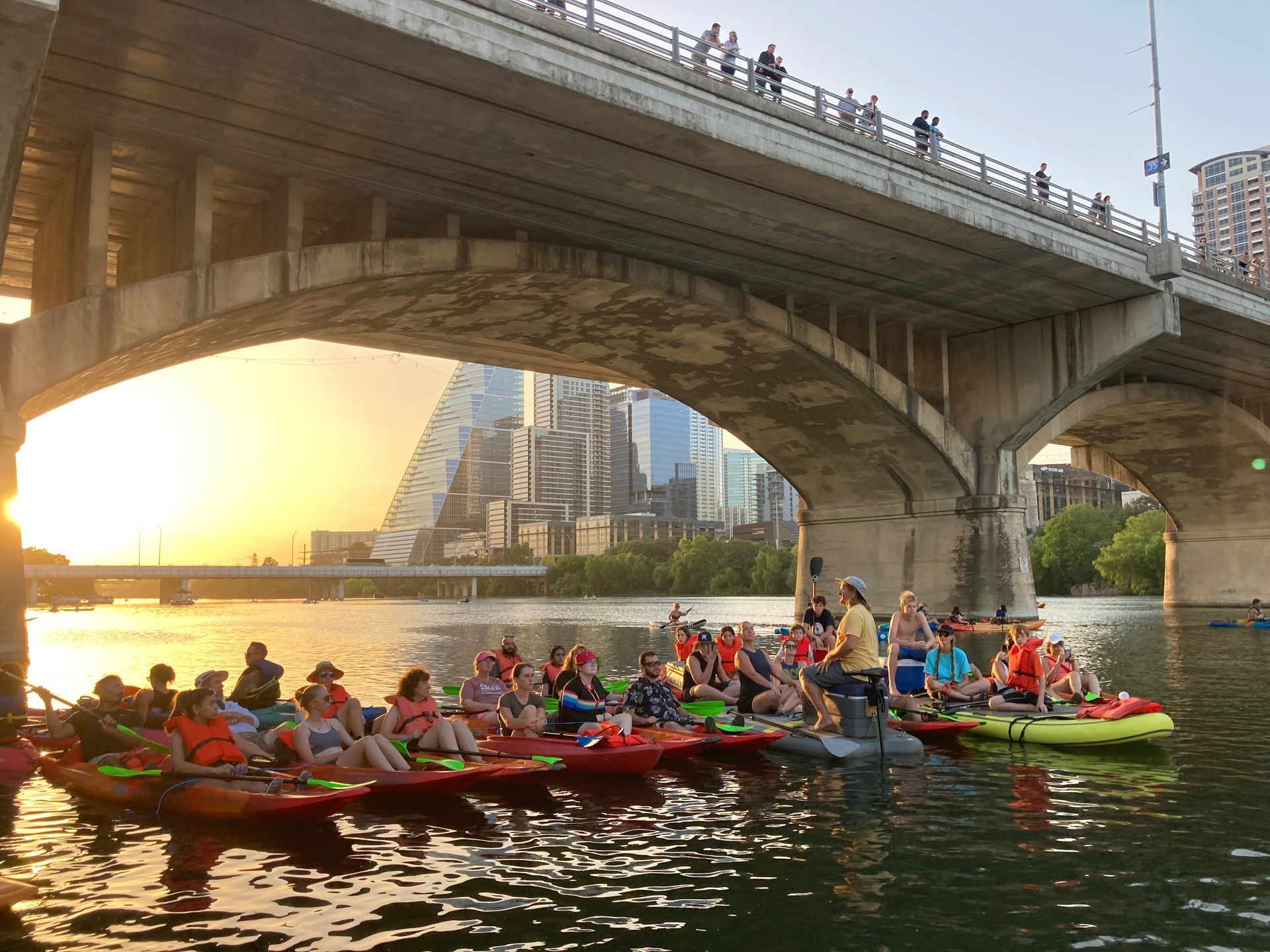 Boats & Bats guide leading paddle tour with guests near downtown Austin