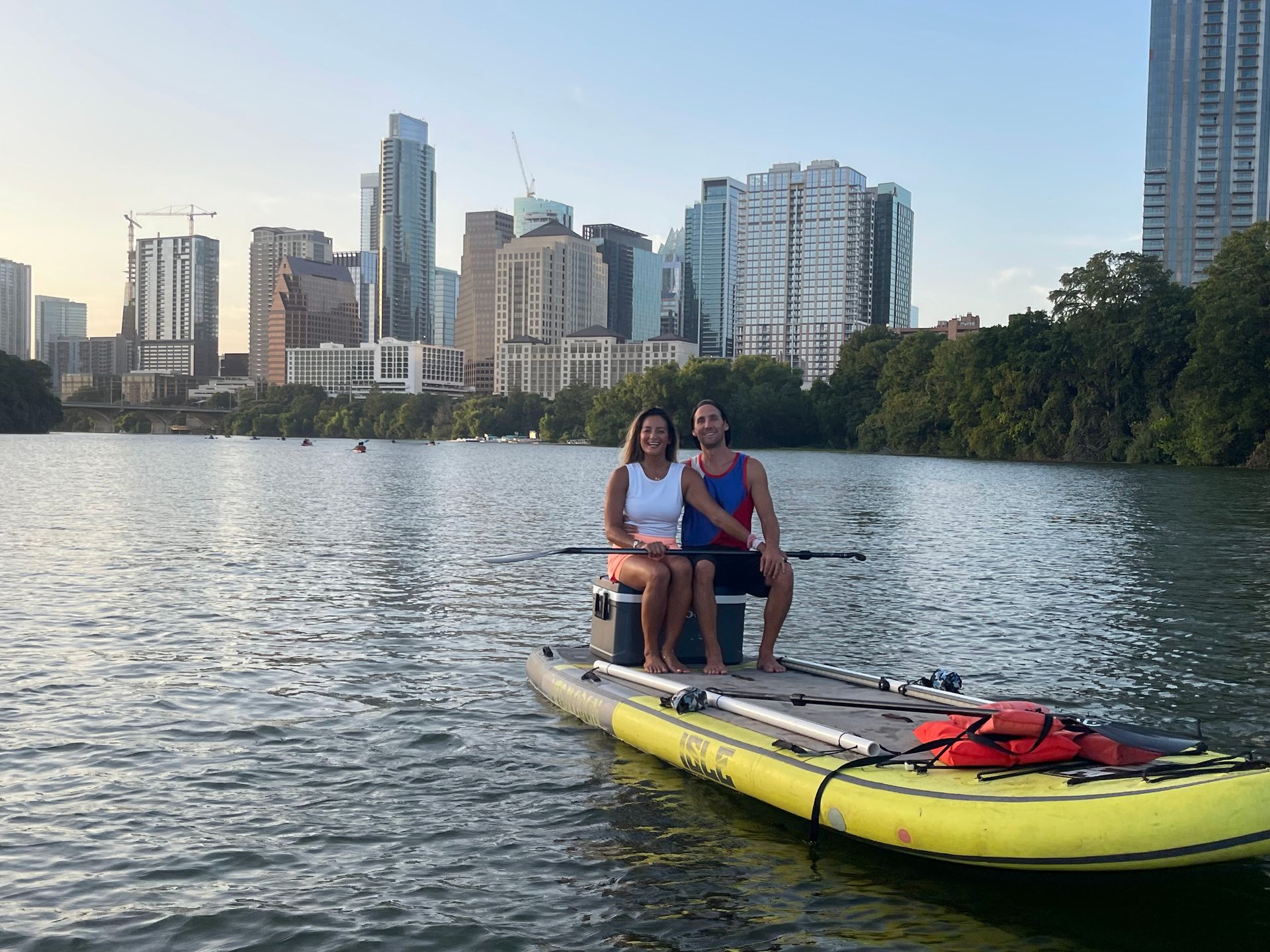 Boats and Bats tour picture on lady bird lake with Austin skyline in background